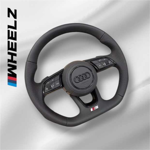 Volant Audi S-Line multifonctions en cuir perforé avec airbag pour une conduite dynamique.